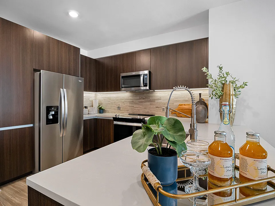 Designer kitchen with stainless appliances and polished island