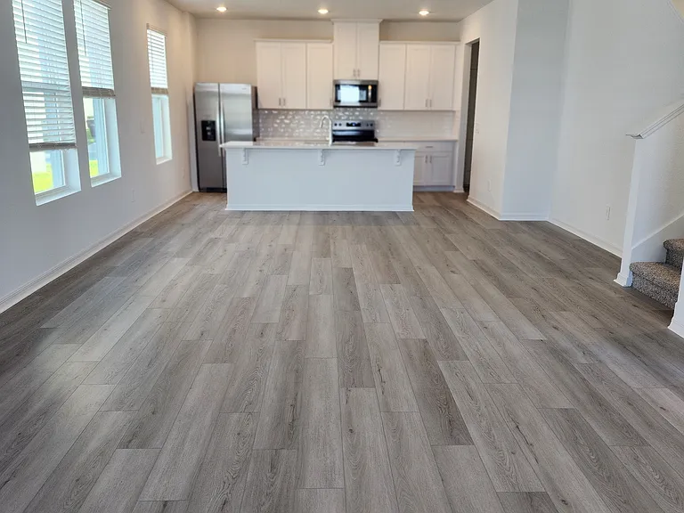Open Great Room with wood looking tiles.