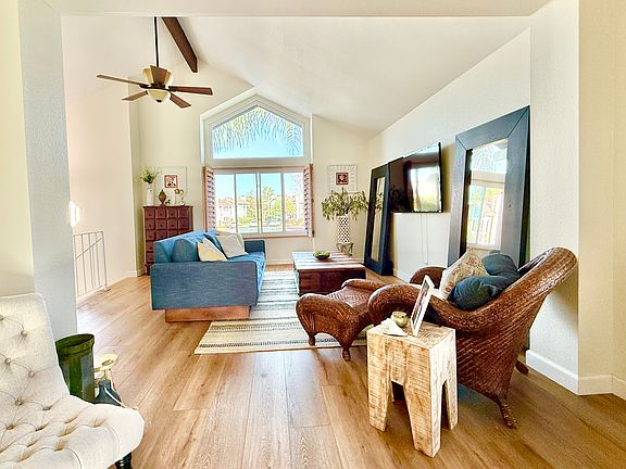 Vaulted ceilings and huge window brings in natural light to your living room.