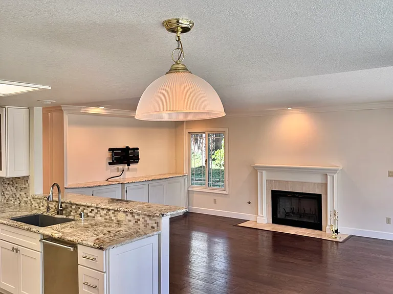 Open floor plan with kitchen, breakfast area, and family room
