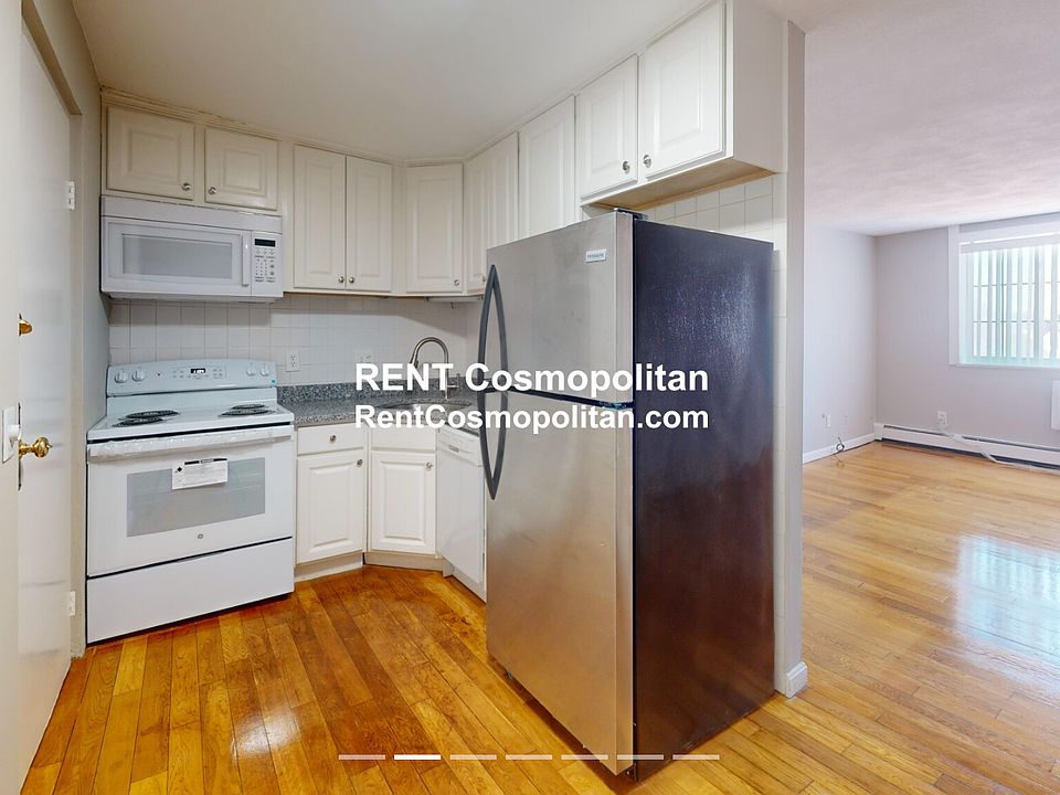 Granite kitchen with dishwasher, stove, microwave and refrigerator