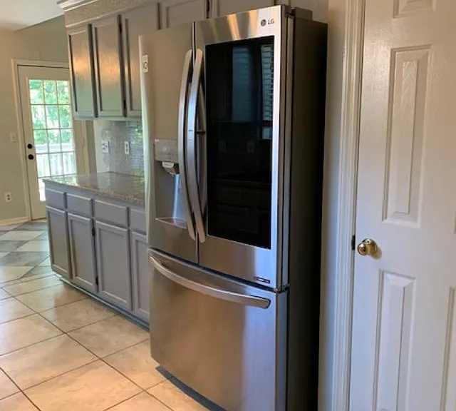 View of pantry, frig and side cabinets in kitchen