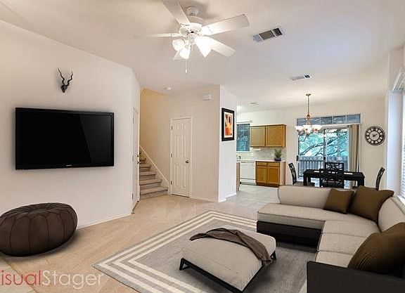 Spacious living area has new carpet and plenty of windows.
