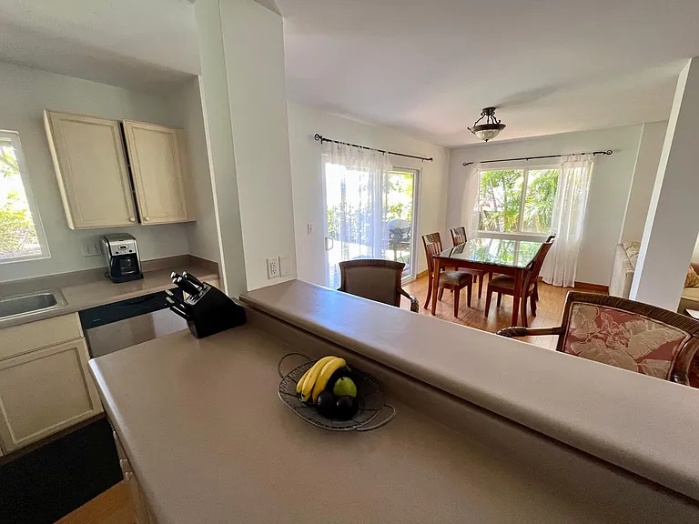 kitchen island and dining table with 6 chairs (2 not shown)