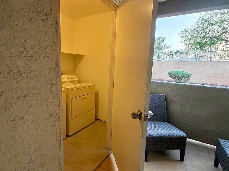Private laundry room with washer and dryer included, conveniently located off the covered patio for added functionality and everyday ease.