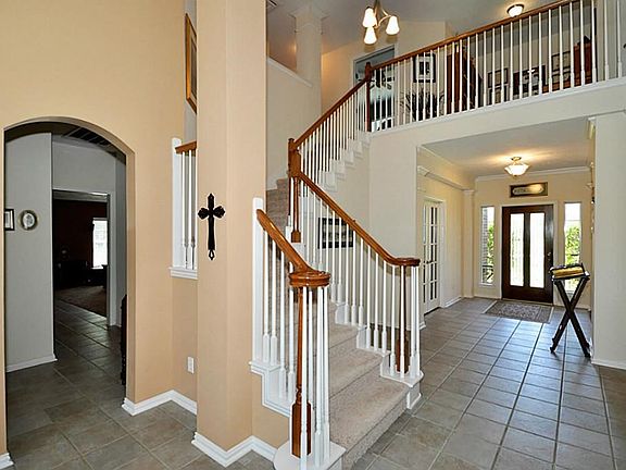ANOTHER VIEW OF THE ENTRY AND THE STAIRCASE TO UPSTAIRS