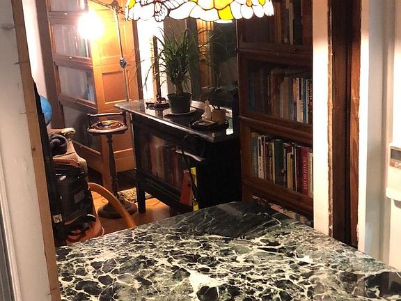 Work station overlooking the sunroom, waterfall, and garden is perfect for telework or sitting with your morning coffee.