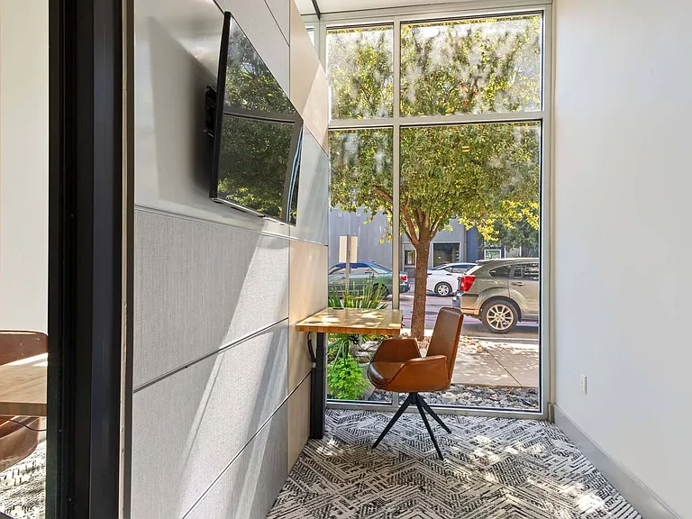 Work in a spacious, sunlit environment where expansive windows invite fresh air and a sense of calm.