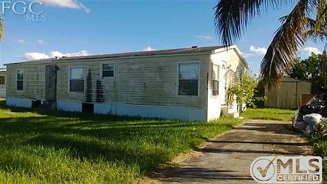Front View of home with paved driveway.
