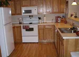 Kitchen with wood panel floors; all appliances included