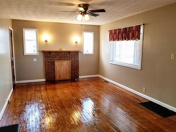 Living Room with Real Hard Wood Floors and Brick Fireplace, Lots of Light!