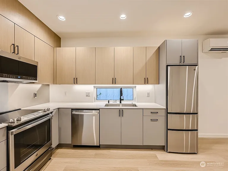 Kitchen. Fridge has been upgraded to an extra-large from pictured and cabinetry extended right 6 inches for additional storage!