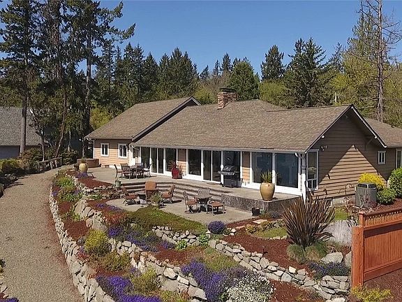 Backside of home, notice the hot tub and easy walk path to waterfront