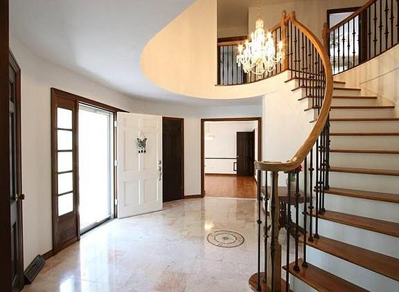 Dynamic Foyer...Marble flooring w/ encased compass...crystal chandelier...curved staircase