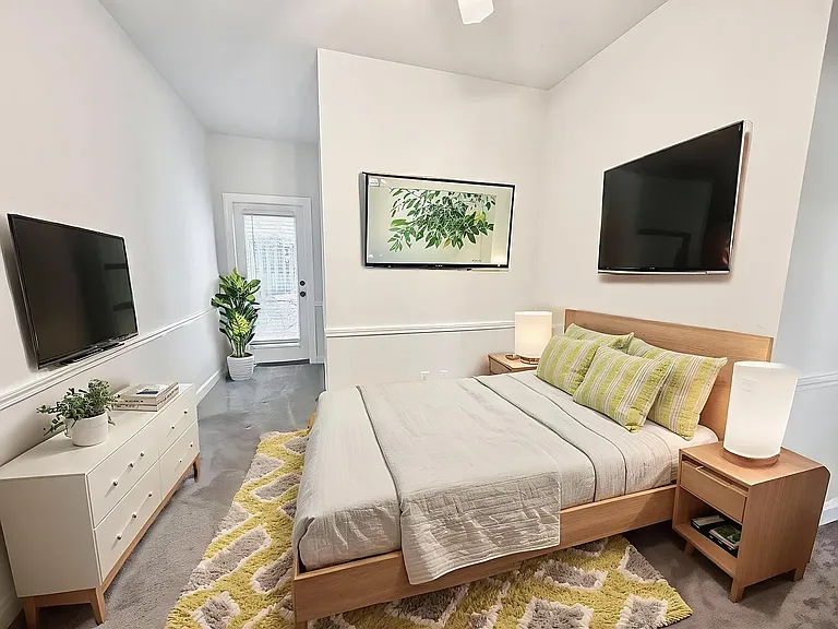 Bedroom 3 virtually staged, door leads to back patio