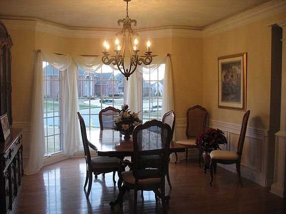 Formal Dining Room Boasts Hardwood Floors and Detailed Moldings!