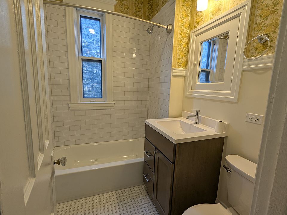 Brand new tub, shower, sink and toilet. Original wallpaper