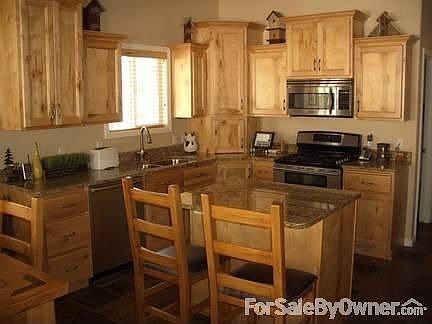 Kitchen, lots of knotty maple cabinets
						:
						Granite countertops, island, slate floor, under-cabinet lighting