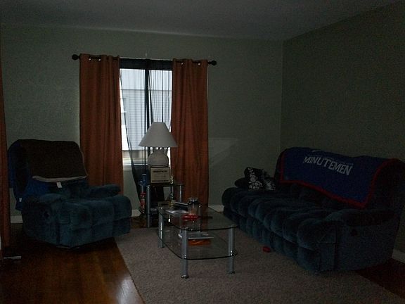 Living room is spacious and has beautiful wood flooring.