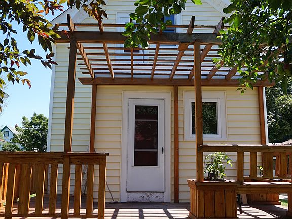 Back deck looks out onto a shaded backyard with apple tree.