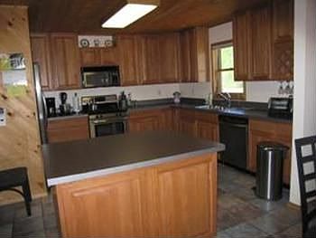 Large oak kitchen with ceramic flooring into the dining area.