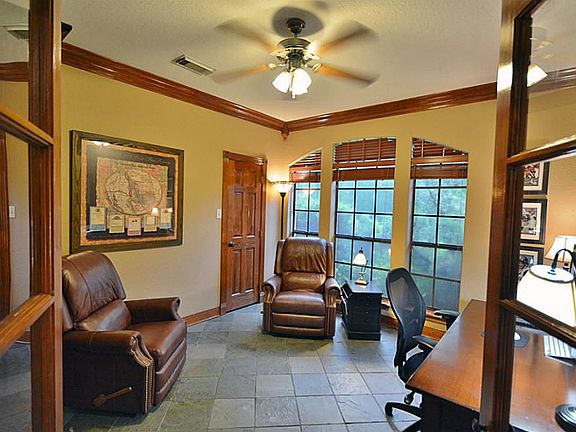 As you enter the home there is a fabulous office or additional bedroom with crown molding, slate flo