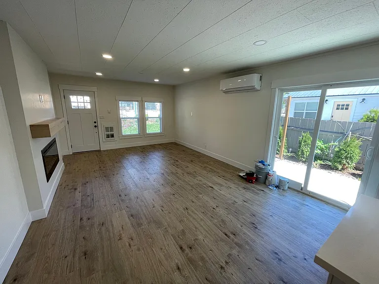 Living space with room for dining, slider to patio. All new surfaces and paint.