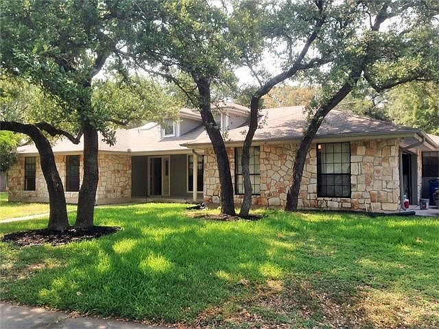 Exterior Front with Oak Grove of trees throughout property