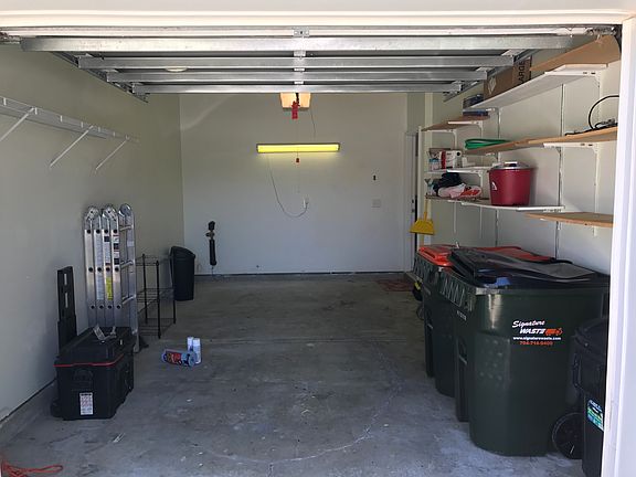 Single car a garage with 2 additional parking spaces.