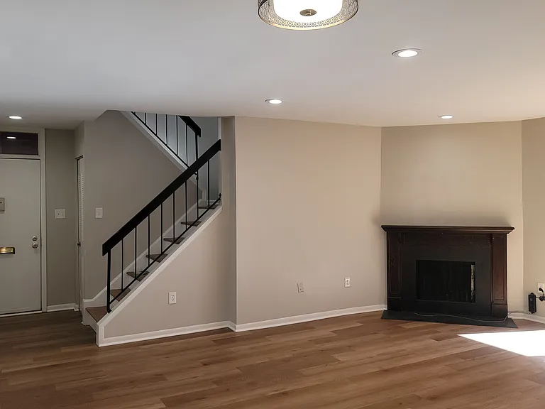 Entryway, stairs, and fireplace
