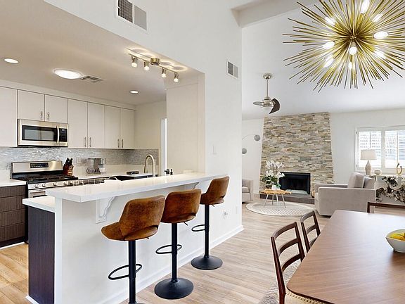 Open kitchen, dining, and living room space.