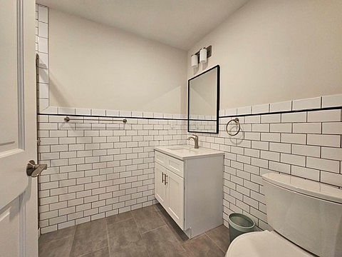 Stylish bathroom with classic white subway tile, a modern vanity, and elegant fixtures. The clean design and warm lighting offer a fresh, upscale feel that enhances the home's overall appeal.