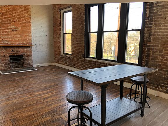 Living room with large windows overlooking Broad and 25th