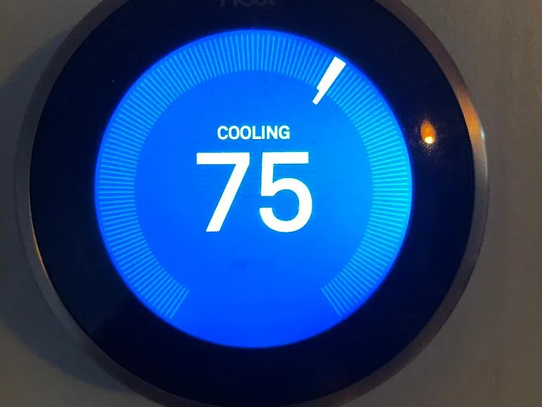 Smart Nest thermostat that saves energy in several ways. You can use app to control remotely, and set it up to automatically go to eco mode when you are away and back to regular when approaching.