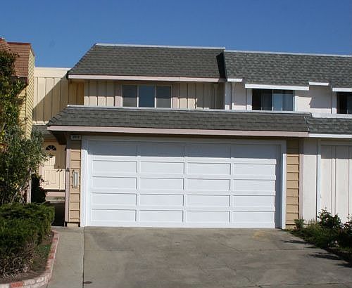Detached garage in front permits a private courtyard entry way