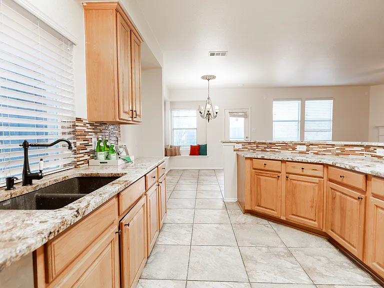 Lots of cabinets in kitchen, window above sink