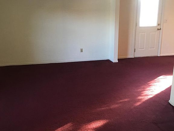 Living room going into dining room with patio door