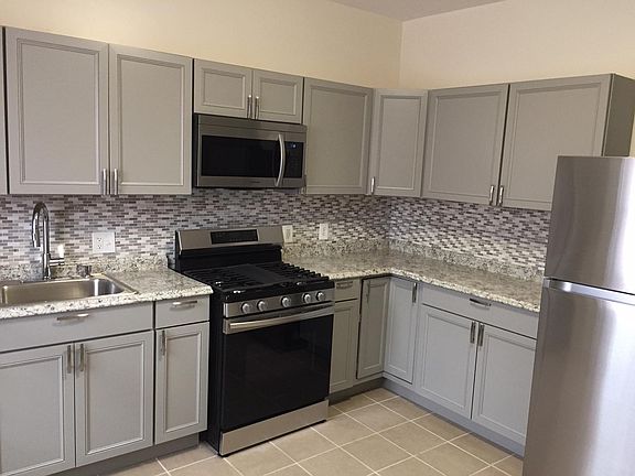 Kitchen with new cabinets, flooring, counters and appliances. Dishwasher included.