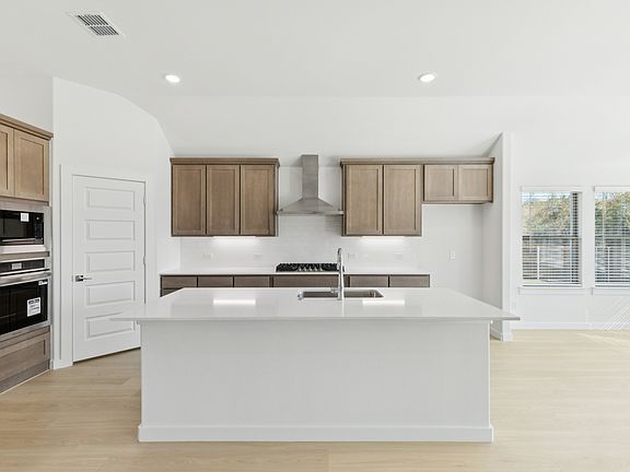 Kitchen in the Gilmour II home plan by Trophy Signature Homes - REPRESENTATIVE PHOTO