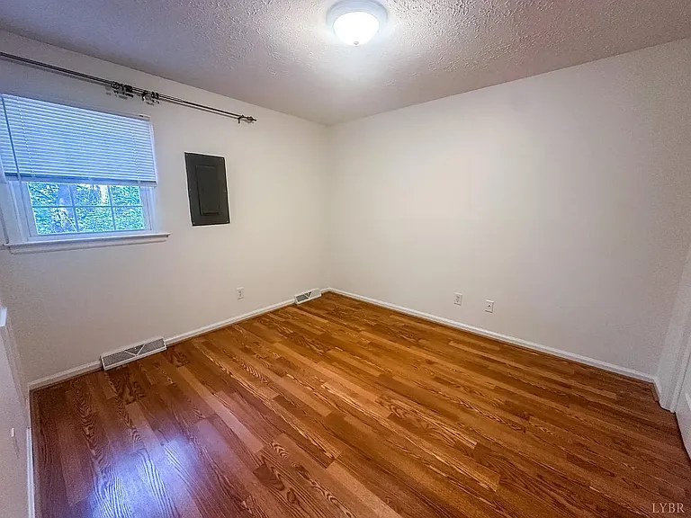 bedroom offers a peaceful retreat with a layout that easily accommodates a full or queen sized bed along with additional furnishings. Enjoy the window for natural light during the day and a calm atmosphere for unwinding at the end of the day.