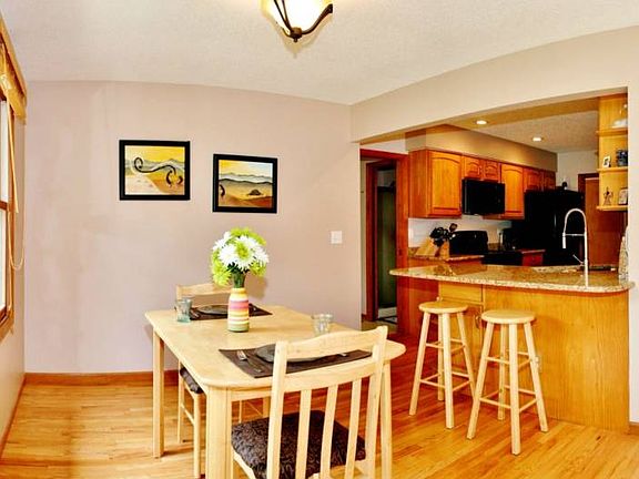 The sunroom is currently used as a casual eating area.  Double doors lead to the pool room just beyond and sliding doors to the deck.