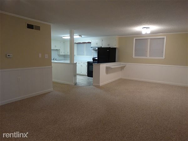 Entry view into living room, dining area, and kitchen