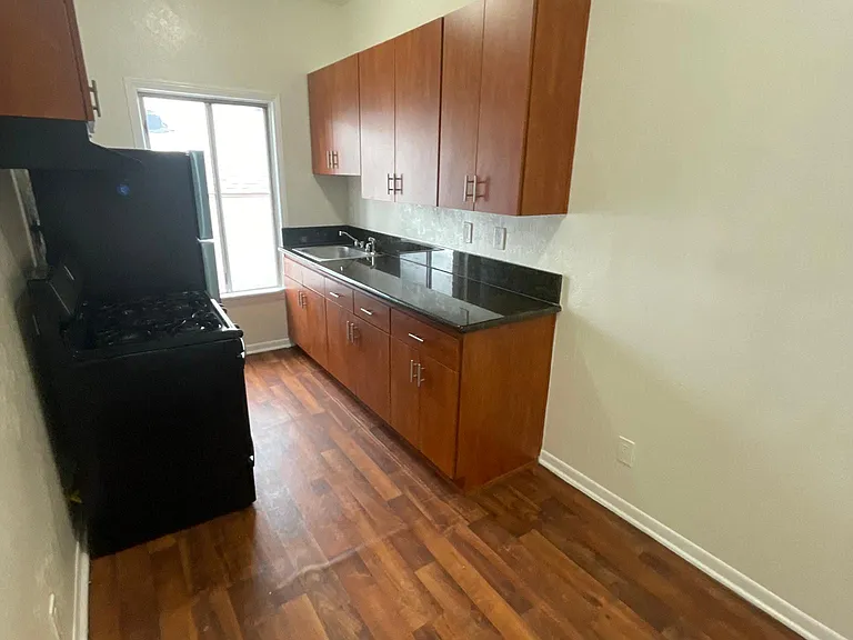 Kitchen with hardwood floors and cabinets at Sanborn/Hoover Apartments in Los Angeles, CA.