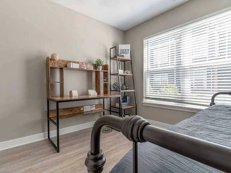 Second bedroom with large, bright windows and plank flooring
