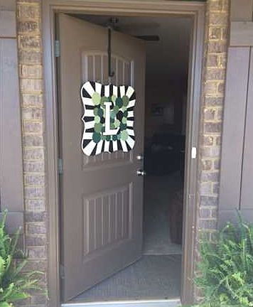 THE HOME HAS A LARGE FRONT PORCH WITH A BEAUTIFUL FRONT DOOR
