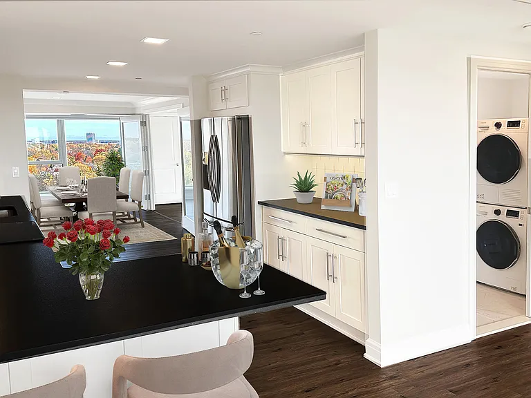 OUTSTANDING CULINARY KITCHEN AND VIEW TO DINING AREA...NOTE THE LAUNDRY ROOM OFF TO THE SIDE