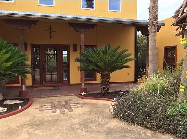 From the Courtyard, front door, pool and garage entry off to