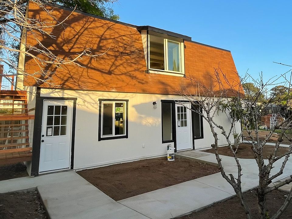 Private entrance to upper unit (left); separate entrance to lower studio (right)