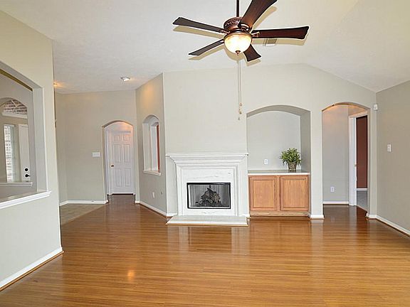 Family Room has Entertainment Niche, Gas Log Fireplace,Updated Lighting & Fan