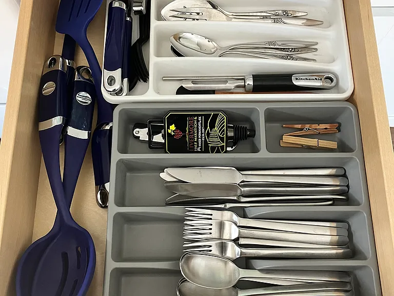Flatware and cooking utensils are included.